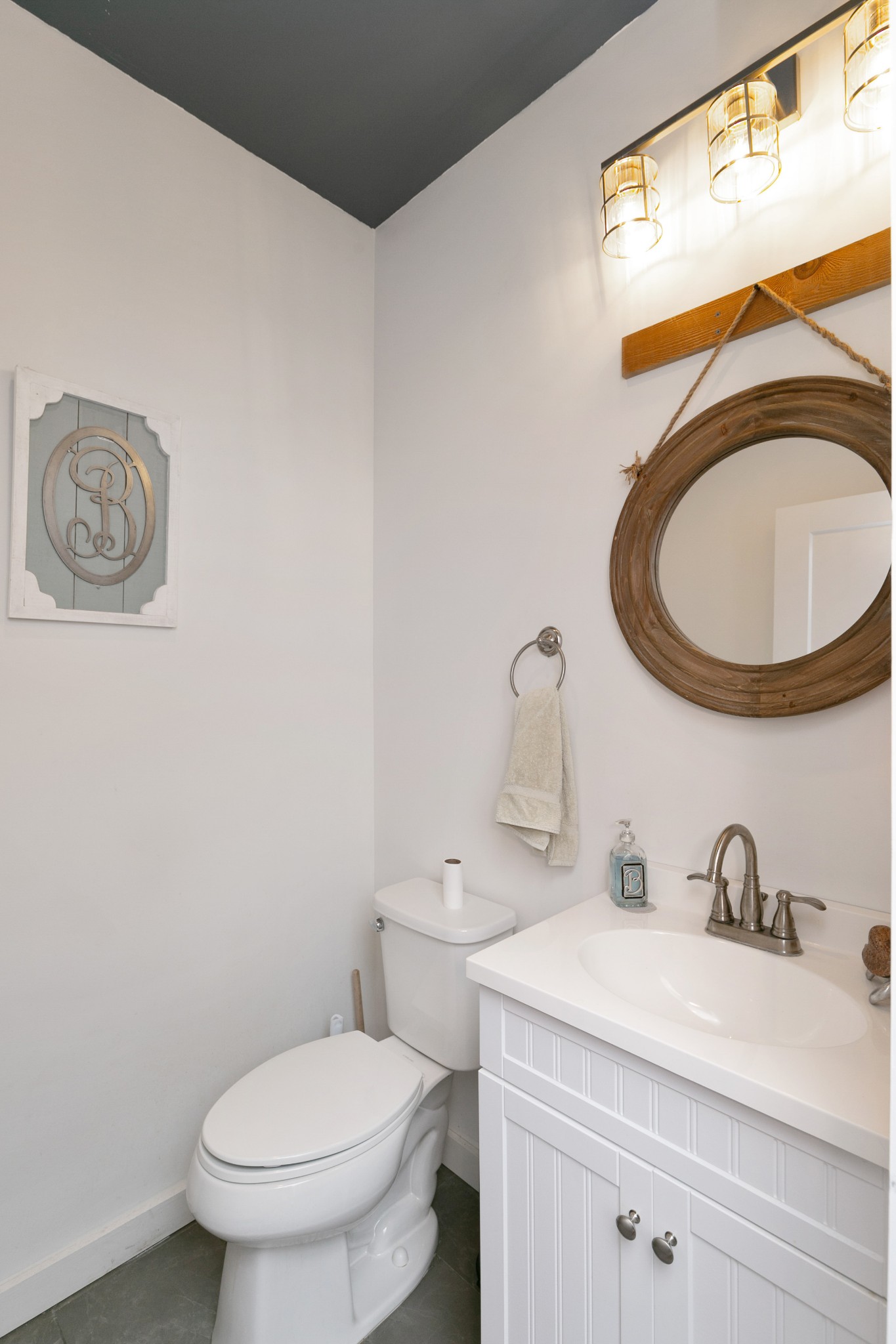 4920 Galen Road Lafayette, TN 37083 - Photo 22 of 47 a bathroom with a toilet sink vanity and mirror