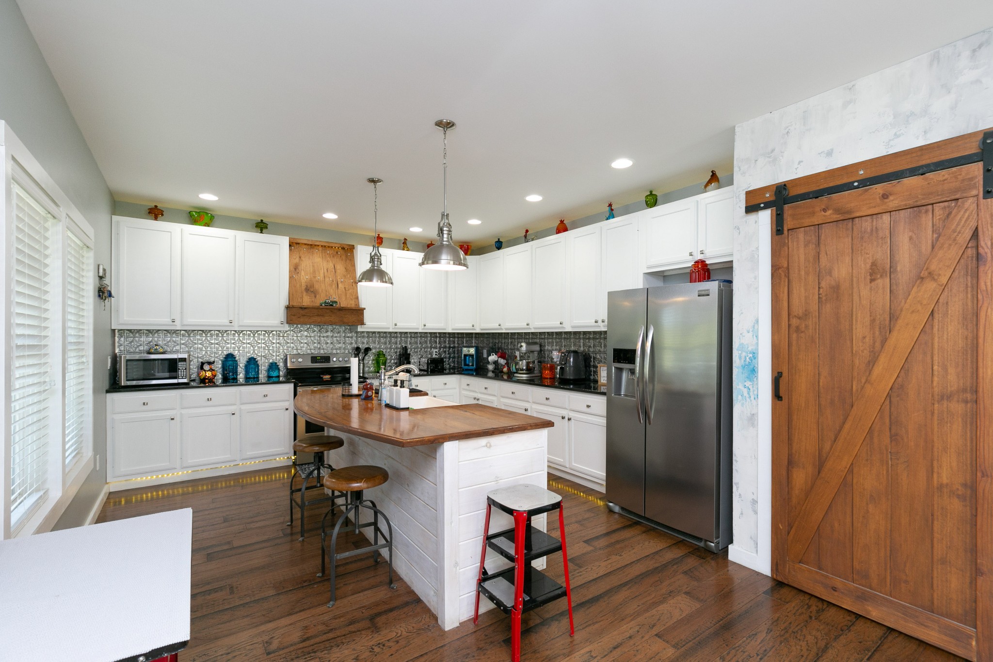 4920 Galen Road Lafayette, TN 37083 - Photo 8 of 47 a kitchen with a refrigerator a counter space and wooden floor
