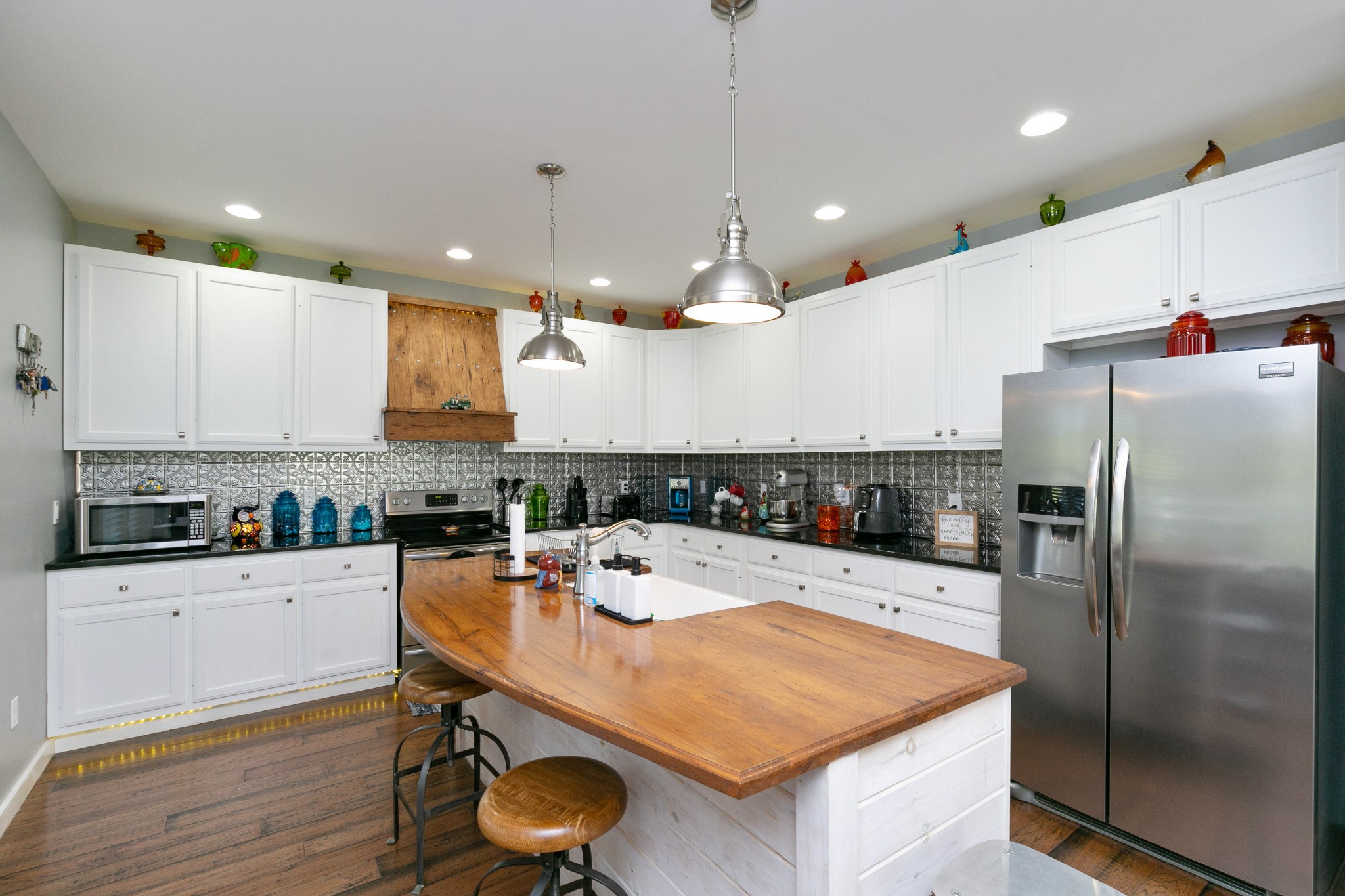 4920 Galen Road Lafayette, TN 37083 - Photo 9 of 47 a kitchen with a white center island a sink cabinets and stainless steel appliances