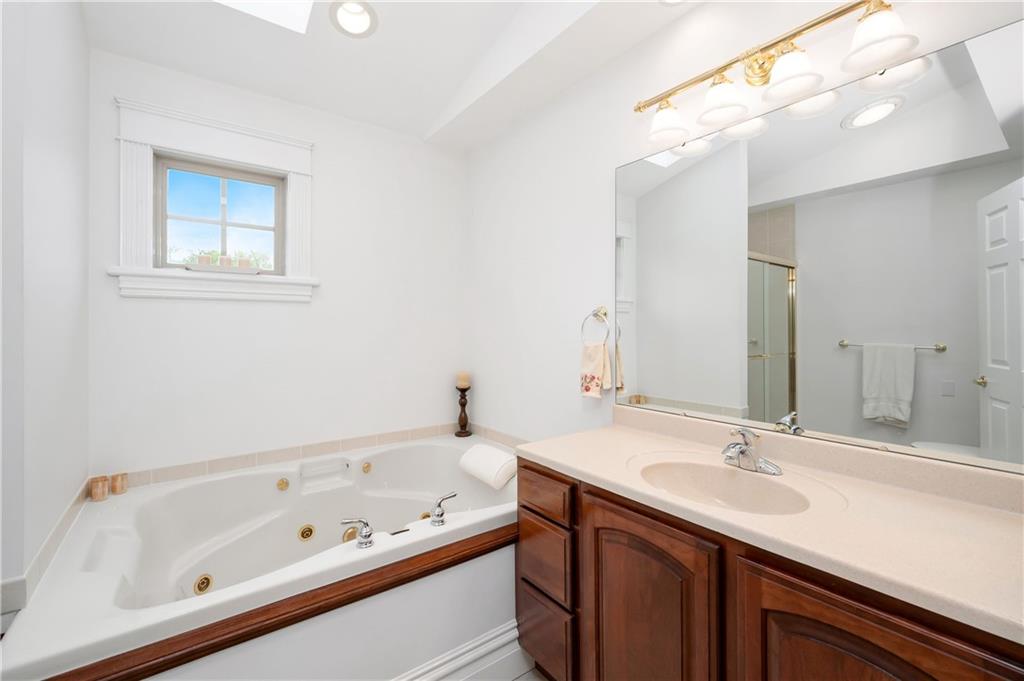 829 Hartzell School Road New Brighton, PA 15066 - Photo 21 of 50 a bathroom with a tub a sink and mirror