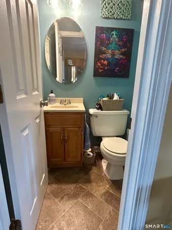 a bathroom with a toilet sink and mirror