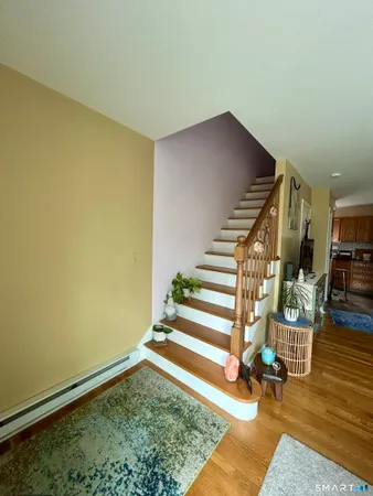 a view of entryway and hall with wooden floor