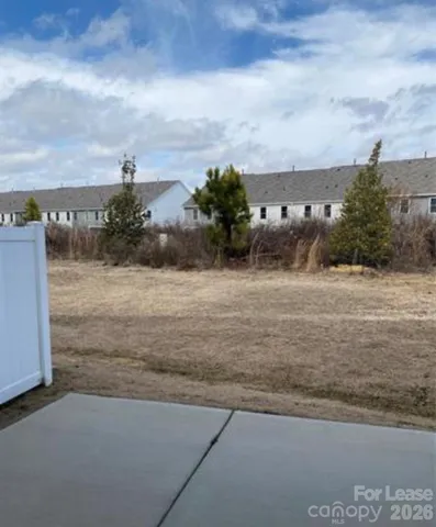 a view of a pathway both side of building with yard
