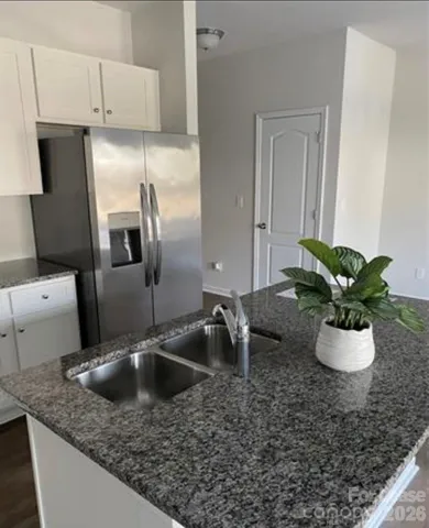 a kitchen with a sink and a refrigerator
