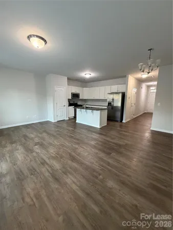 a view of a kitchen with a sink and a refrigerator