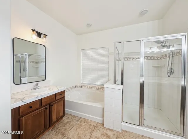 a bathroom with a tub sink and mirror