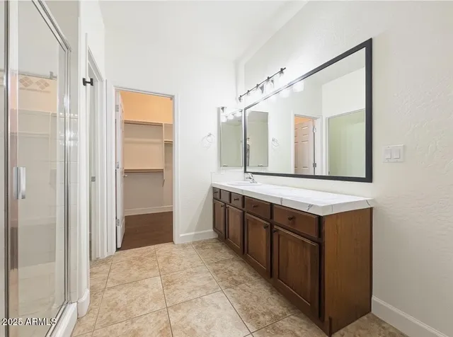 a view of walk in closet with wooden floor