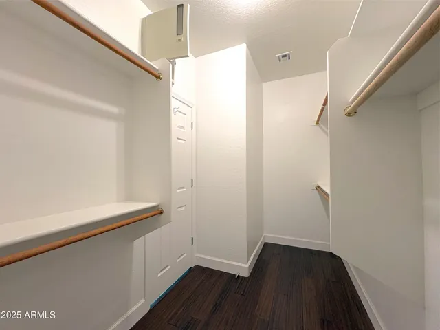 a room with wooden floor and cabinets