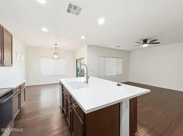a kitchen with stainless steel appliances a stove refrigerator sink and cabinets