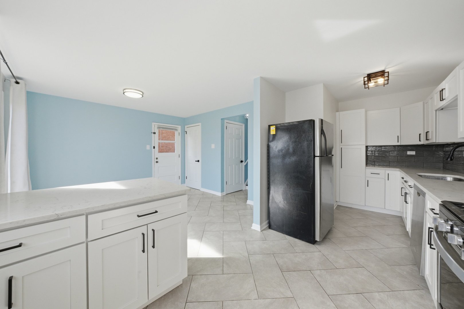 74 West 140th Street Riverdale, IL 60827 - Photo 11 of 37 a kitchen with stainless steel appliances granite countertop a refrigerator a stove and a sink