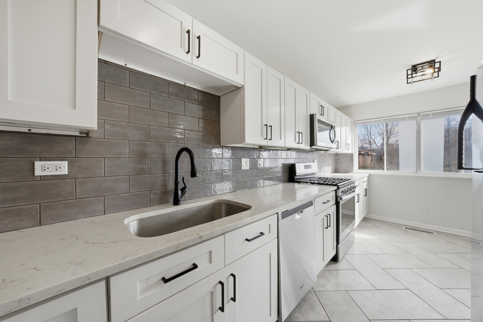 74 West 140th Street Riverdale, IL 60827 - Photo 12 of 37 a kitchen with a sink and cabinets