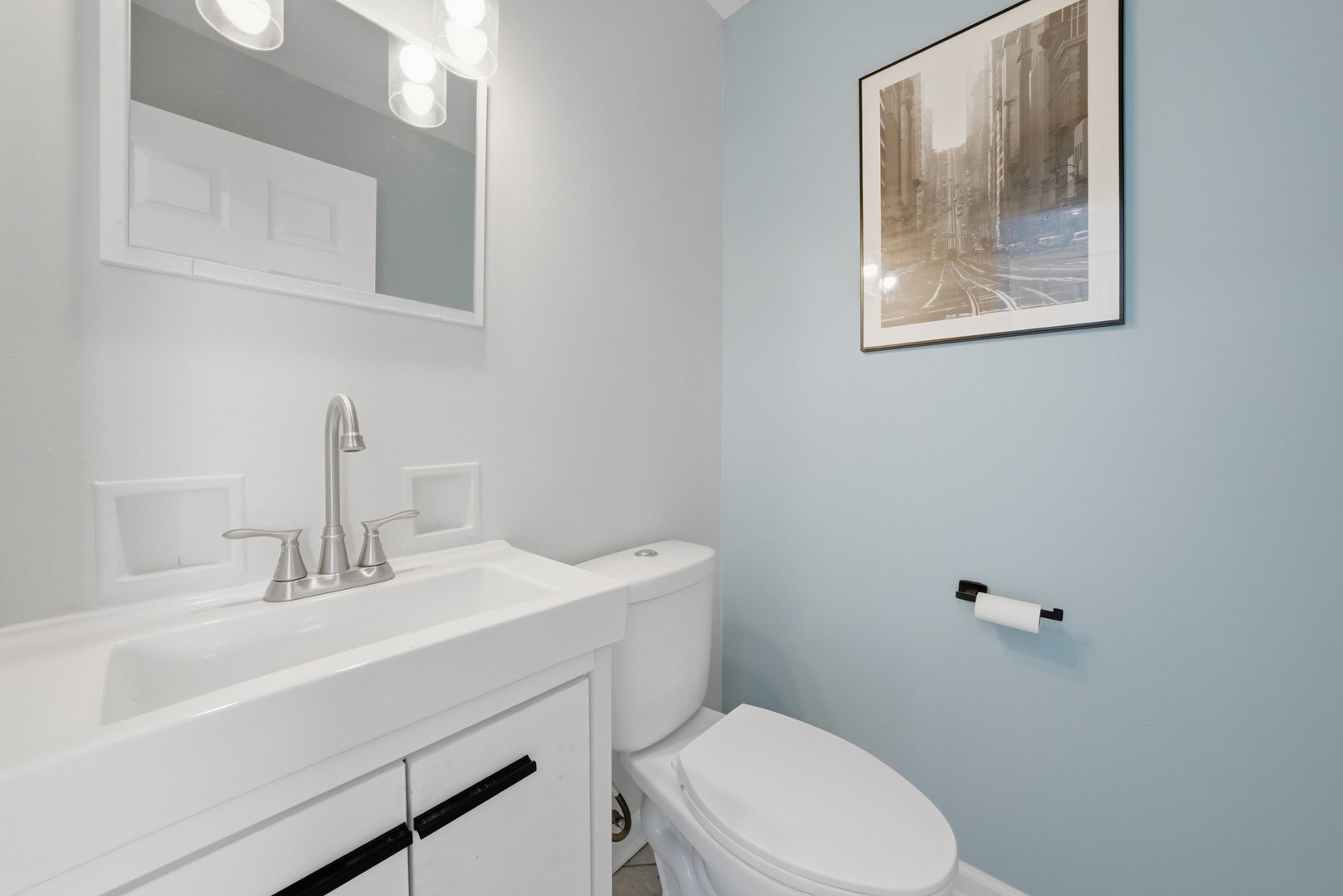 74 West 140th Street Riverdale, IL 60827 - Photo 15 of 37 a bathroom with a toilet a sink and mirror