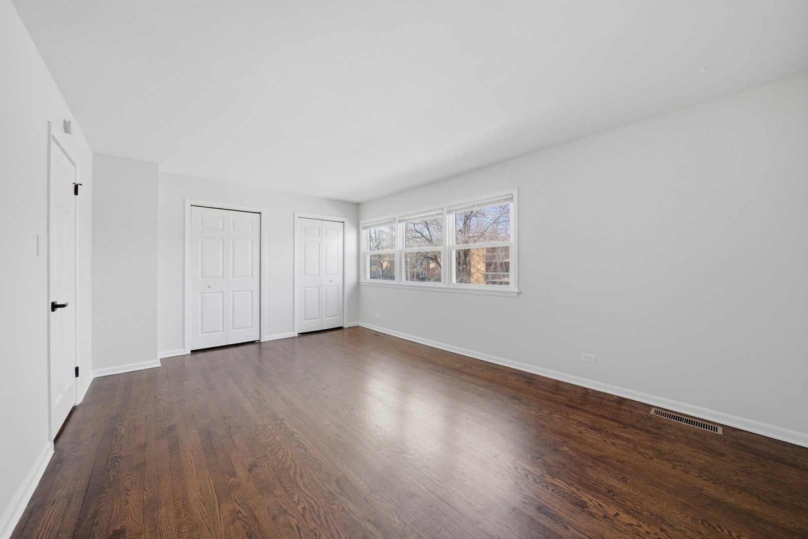 74 West 140th Street Riverdale, IL 60827 - Photo 17 of 37 a view of an empty room with wooden floor and a window