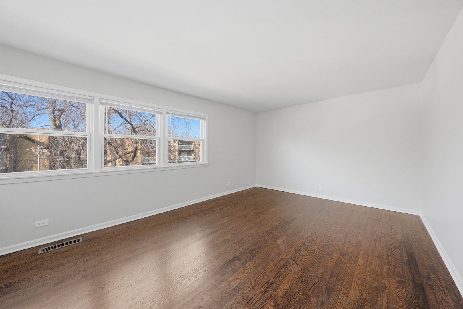 74 West 140th Street Riverdale, IL 60827 - Photo 18 of 37 a view of an empty room with wooden floor and a window