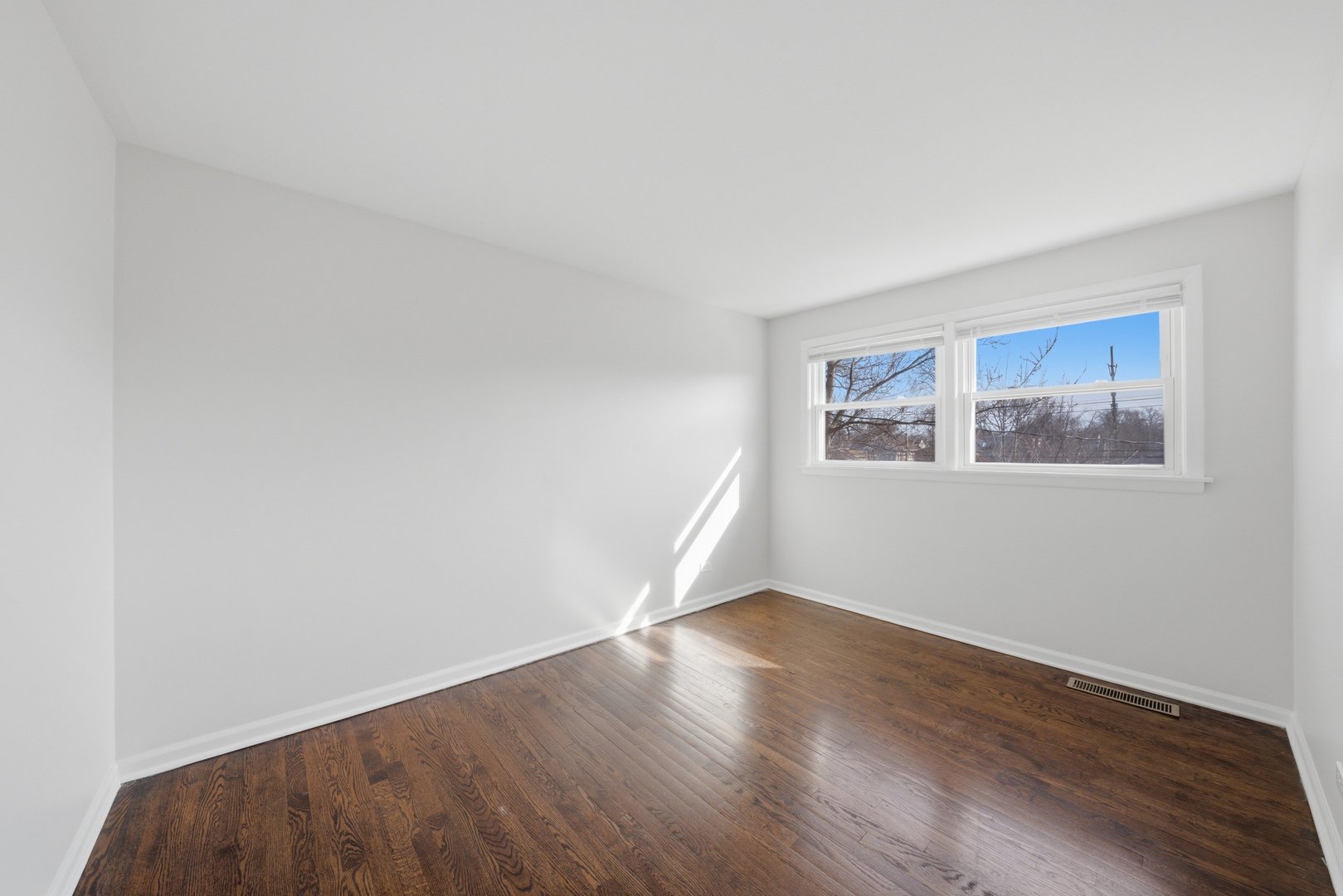 74 West 140th Street Riverdale, IL 60827 - Photo 19 of 37 a view of a big room with wooden floor and windows