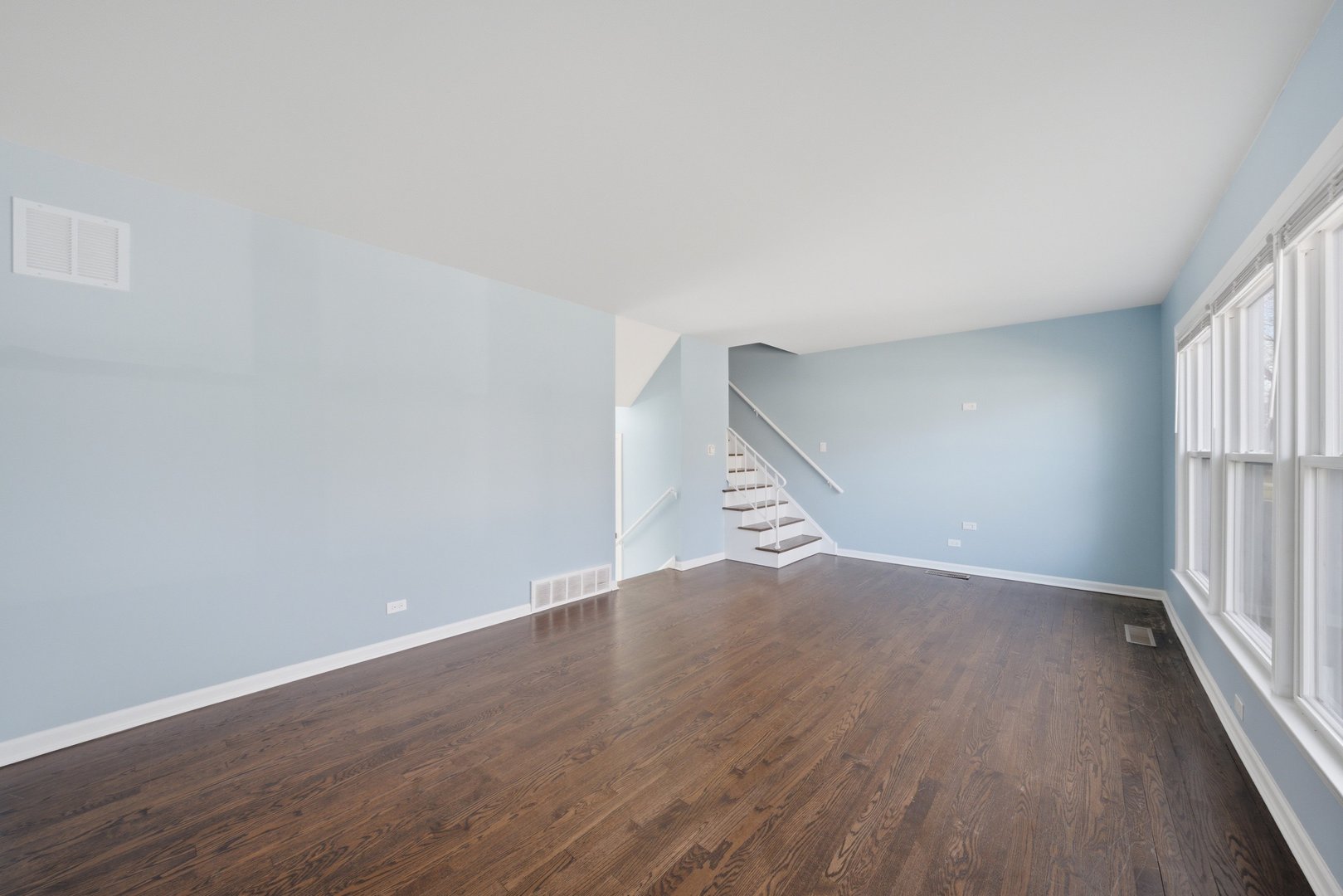 74 West 140th Street Riverdale, IL 60827 - Photo 2 of 37 an empty room with wooden floor and windows