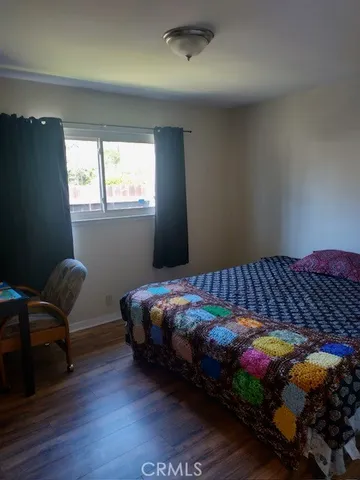 a bed sitting in a bedroom next to a window