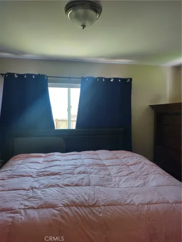 a bedroom with a bed and window