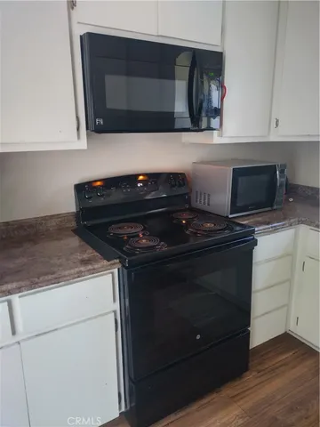a stove top oven sitting inside of a kitchen
