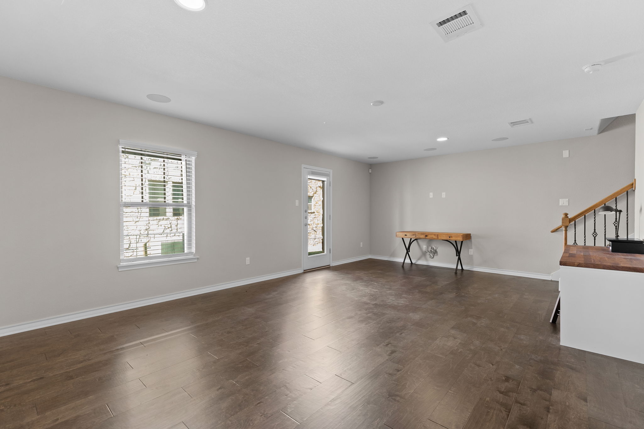 1125 Highknoll Lane Georgetown, TX 78628 - Photo 18 of 40 Empty room with dark wood-type flooring, healthy amount of natural light, and recessed lighting
