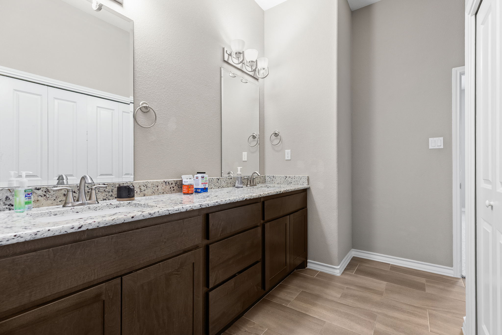1125 Highknoll Lane Georgetown, TX 78628 - Photo 25 of 40 Full bath with double vanity, wood finish floors, and a closet
