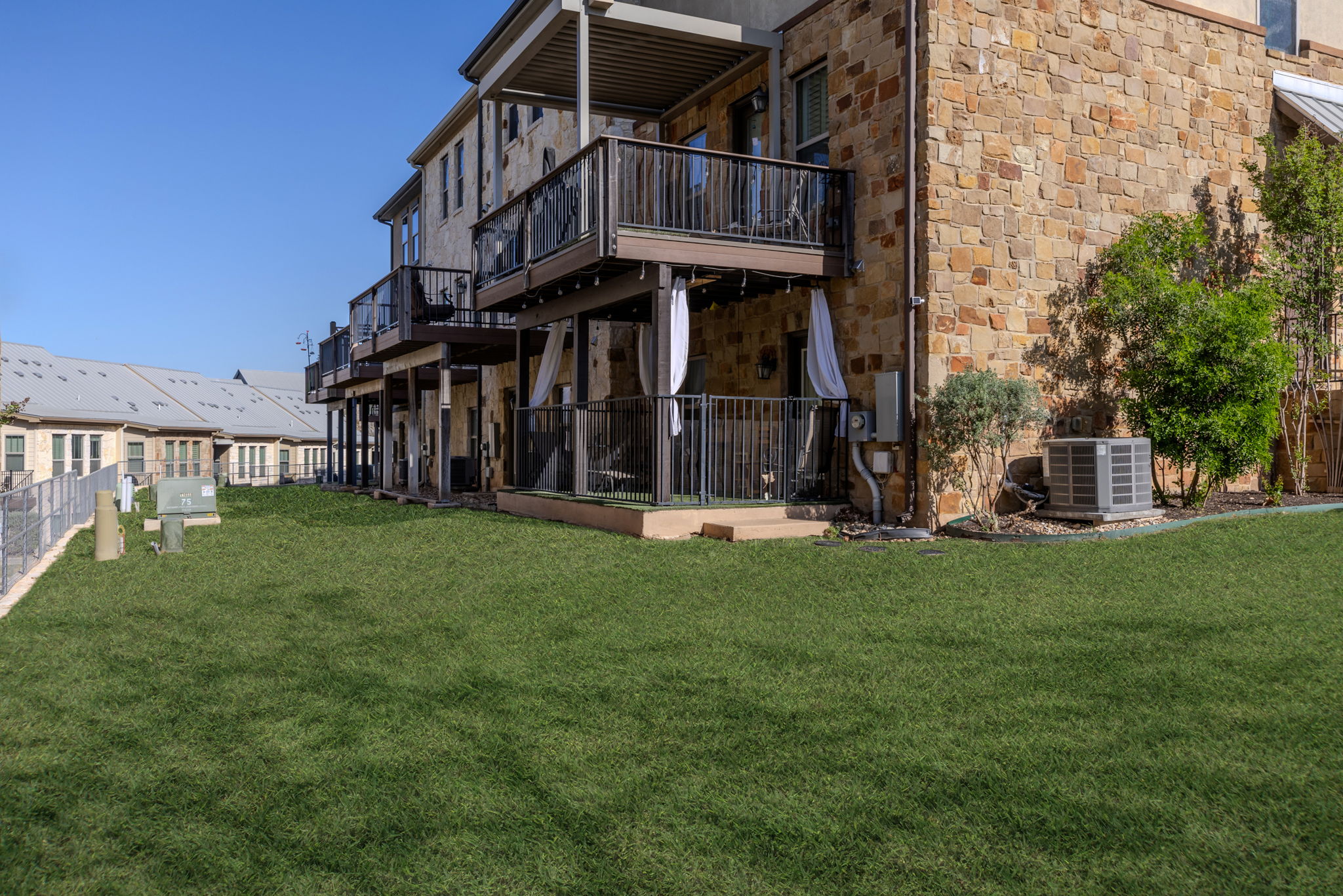 1125 Highknoll Lane Georgetown, TX 78628 - Photo 38 of 40 Back of house with stone siding and a wooden deck