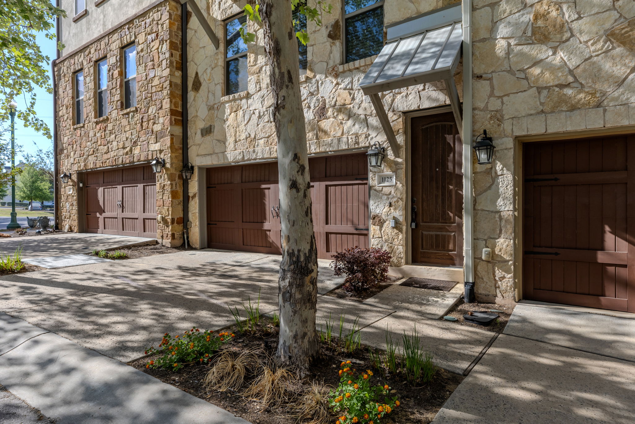 1125 Highknoll Lane Georgetown, TX 78628 - Photo 40 of 40 Entrance to property with stone siding, an attached garage, and concrete driveway
