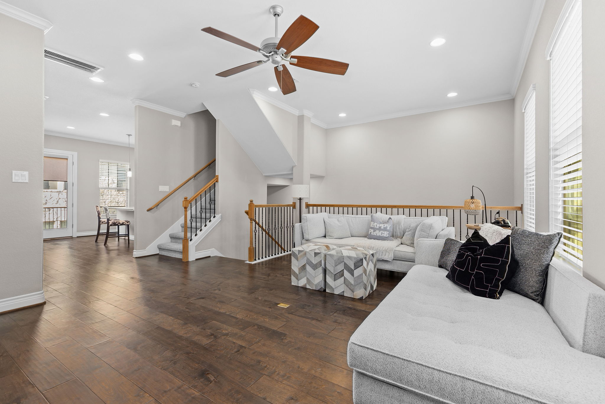 1125 Highknoll Lane Georgetown, TX 78628 - Photo 5 of 40 Living room with ceiling fan, dark wood finished floors, crown molding, and recessed lighting
