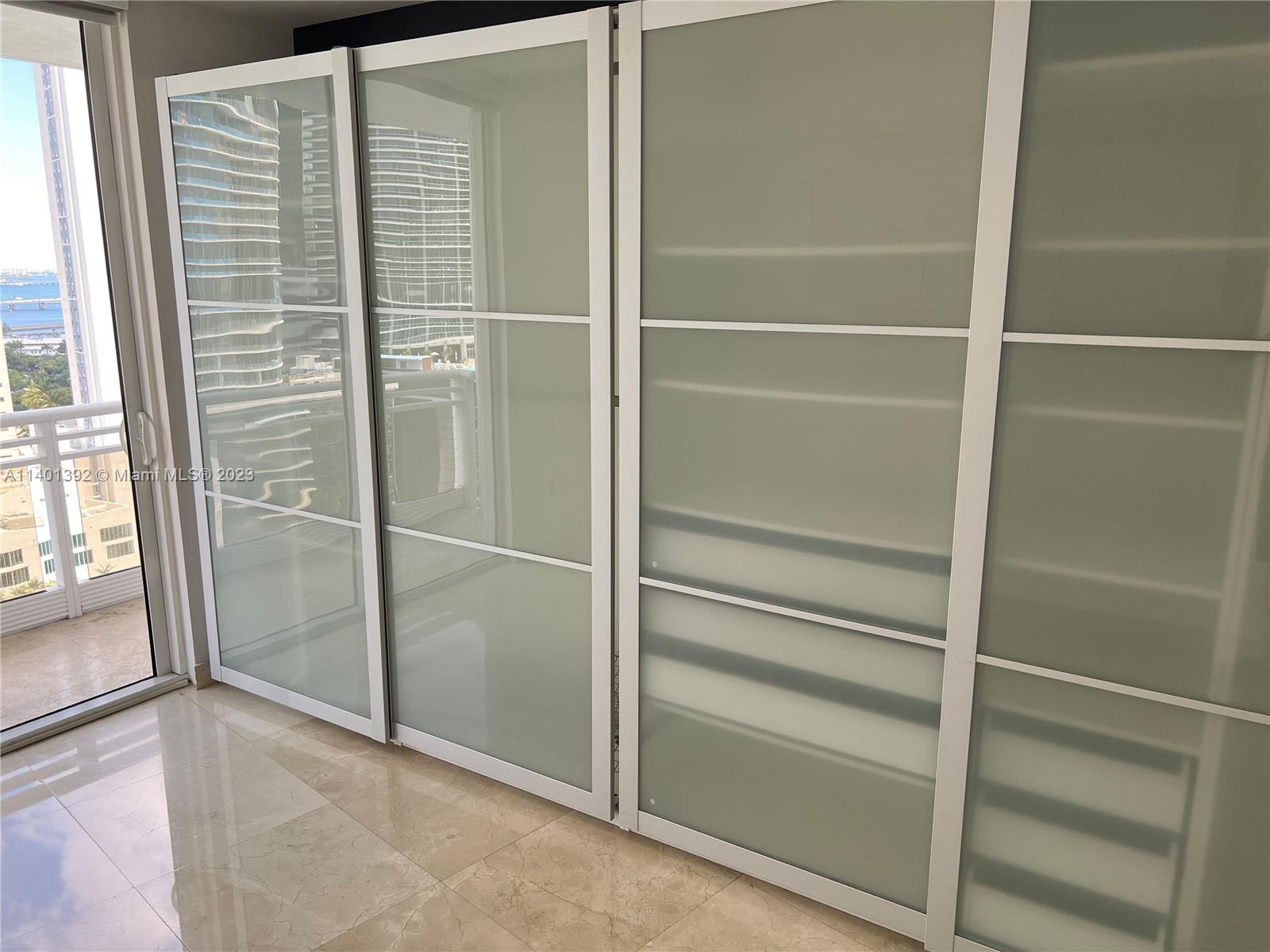 901 Brickell Key Boulevard, Unit 2506 Miami, FL 33131 - Photo 12 of 24 a view of walk in closet with empty racks