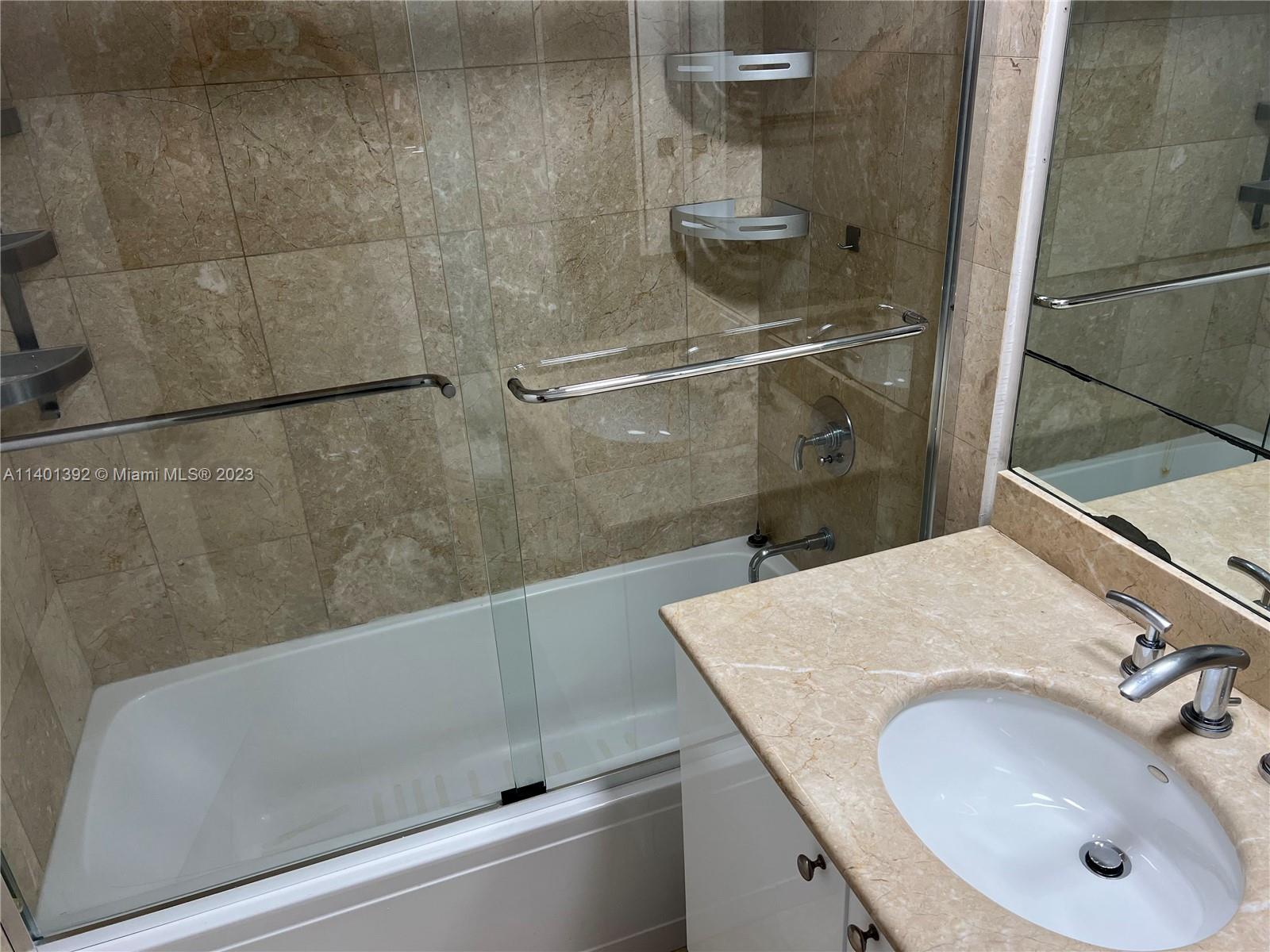901 Brickell Key Boulevard, Unit 2506 Miami, FL 33131 - Photo 14 of 24 a bathroom with a sink and mirror