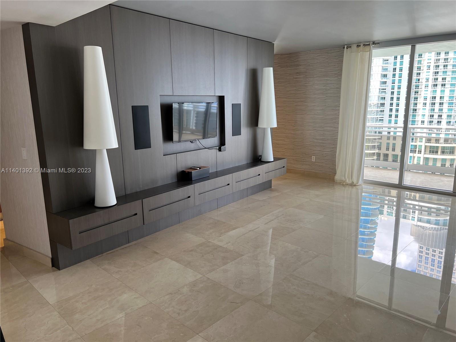 901 Brickell Key Boulevard, Unit 2506 Miami, FL 33131 - Photo 24 of 24 a view of living room with furniture and a window