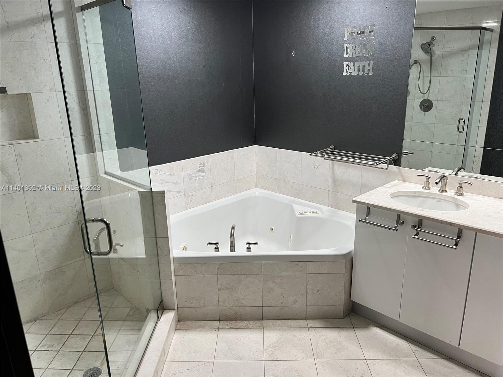 901 Brickell Key Boulevard, Unit 2506 Miami, FL 33131 - Photo 5 of 24 a bathroom with a bathtub and shower