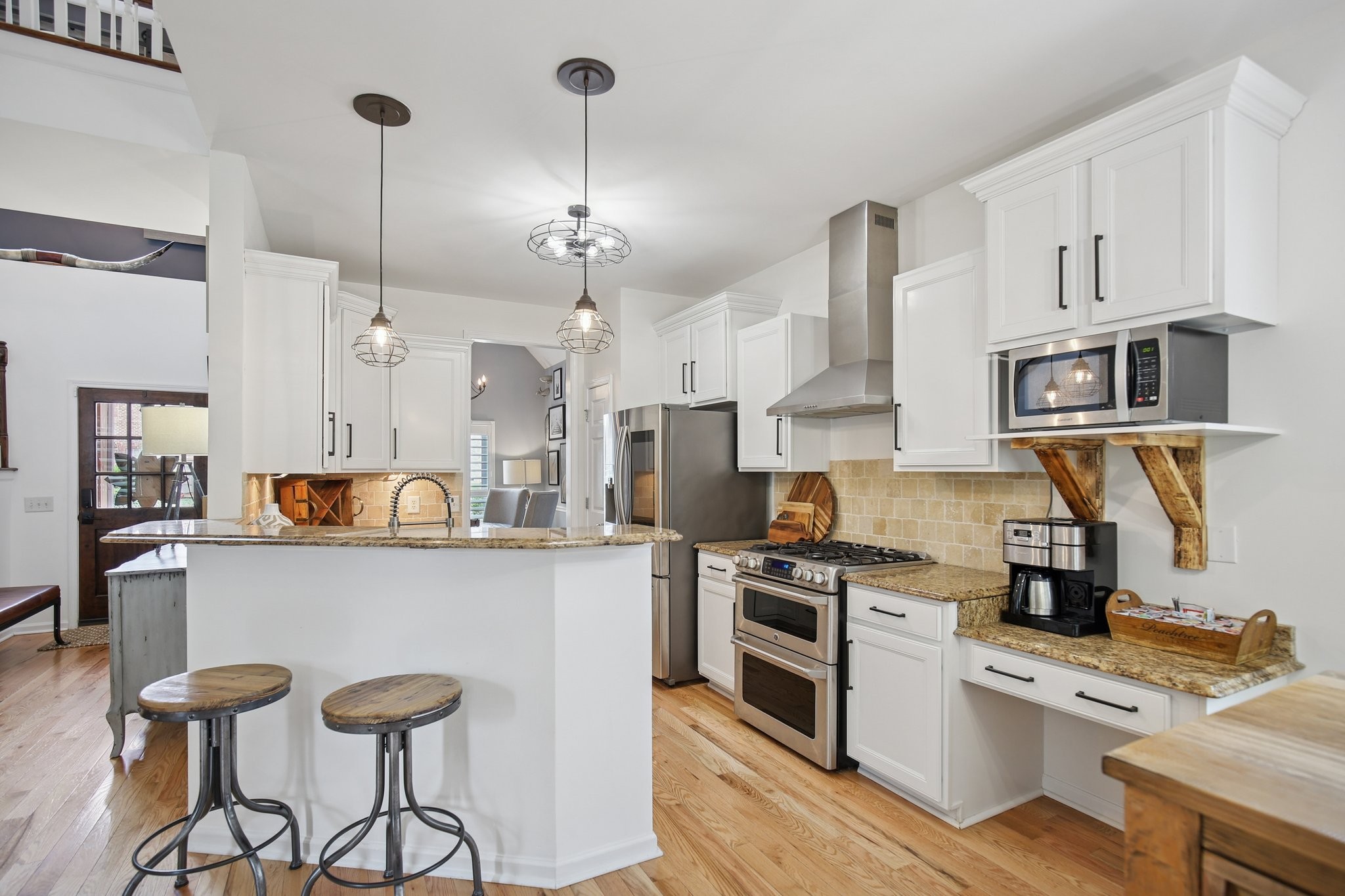 135 Ruland Circle Hendersonville, TN 37075 - Photo 31 of 89 a kitchen with stainless steel appliances kitchen island a refrigerator a stove a sink dishwasher and a stove with wooden floor