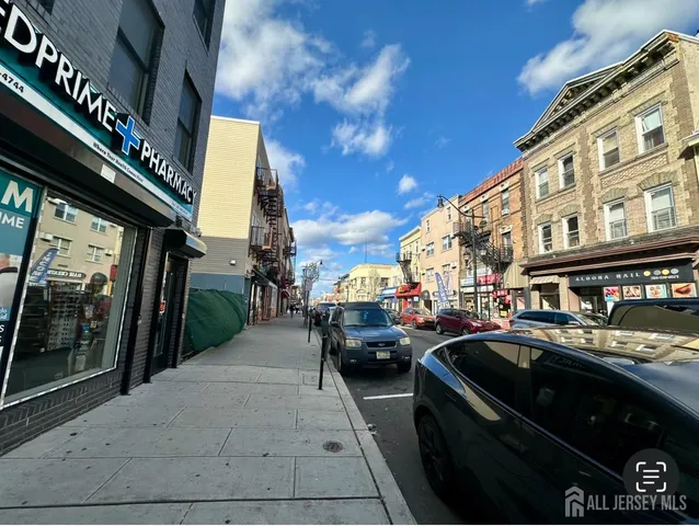 a city street with cars parked in front of buildings