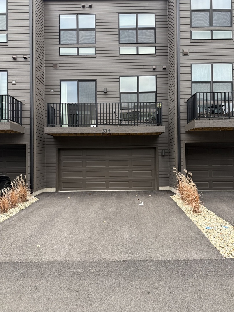 314 Summit Circle Lombard, IL 60148 - Photo 2 of 24 a front view of a house with a garage