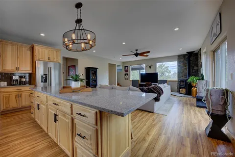 a kitchen with stainless steel appliances granite countertop counter space dining table and chairs
