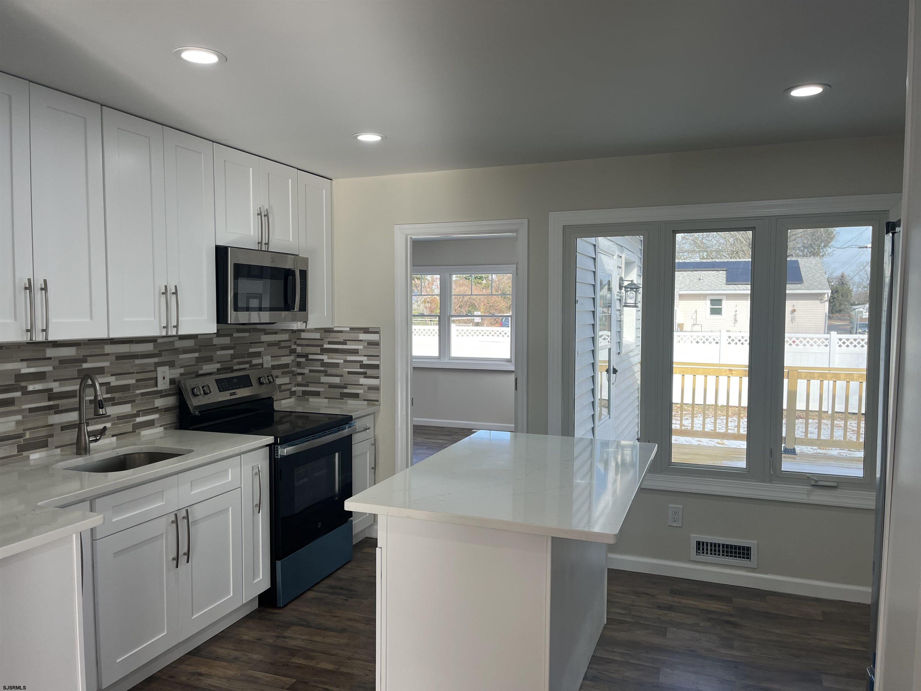 19 Merion Drive Somers Point, NJ 08244 - Photo 1 of 17 a kitchen with a stove a sink and a microwave