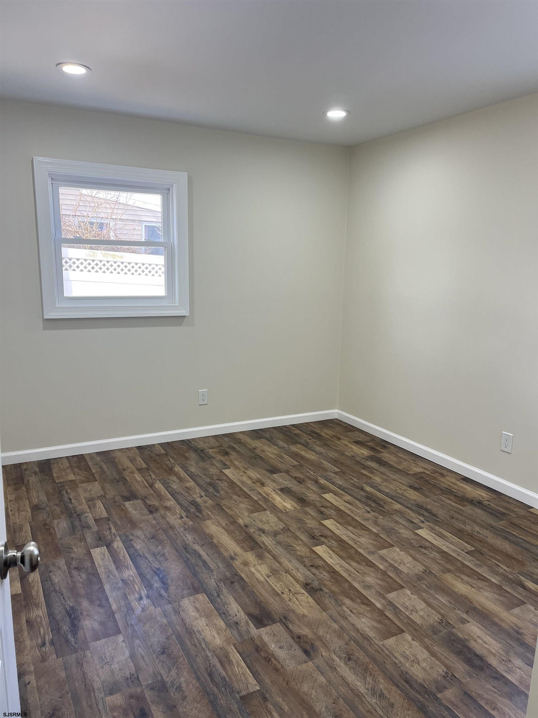 19 Merion Drive Somers Point, NJ 08244 - Photo 13 of 17 an empty room with wooden floor and windows