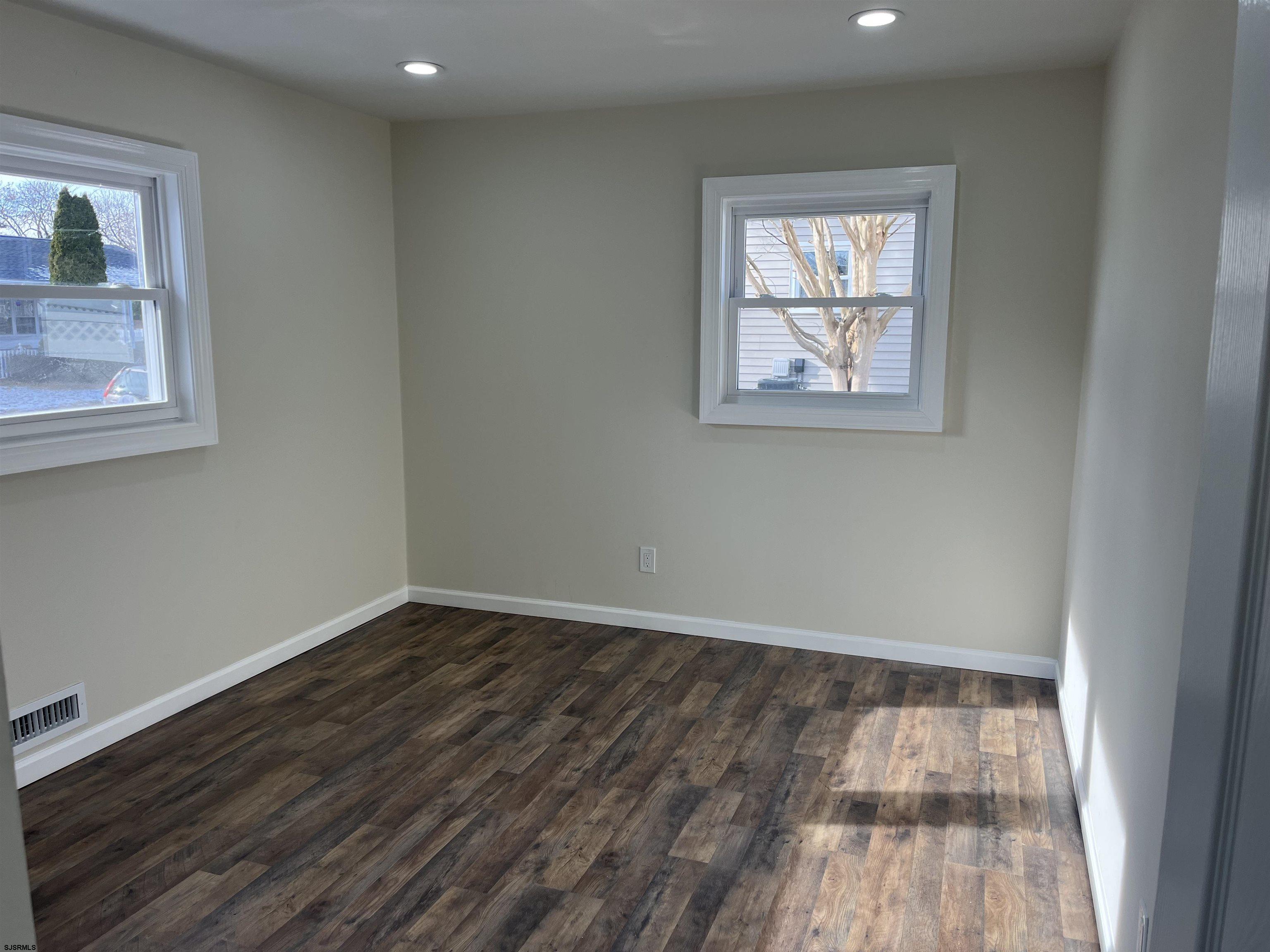 19 Merion Drive Somers Point, NJ 08244 - Photo 5 of 17 an empty room with wooden floor and windows