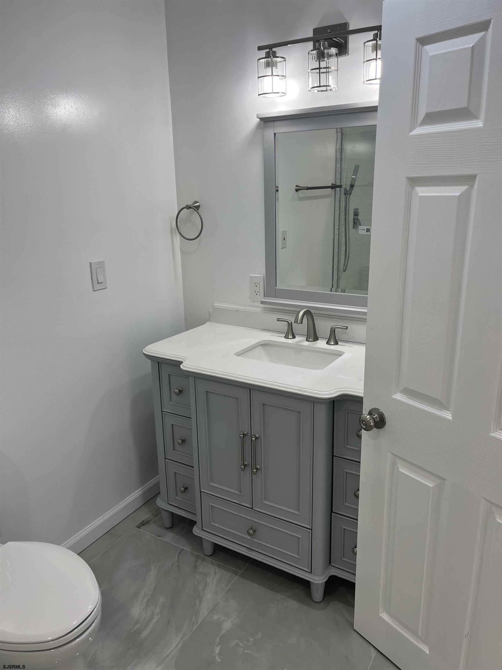 19 Merion Drive Somers Point, NJ 08244 - Photo 7 of 17 a bathroom with a sink vanity and toilet