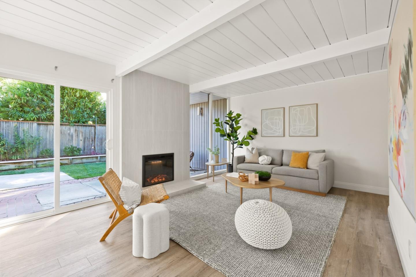 2443 Thaddeus Drive Mountain View, CA 94043 - Photo 2 of 38 a living room with furniture a fireplace and a floor to ceiling window