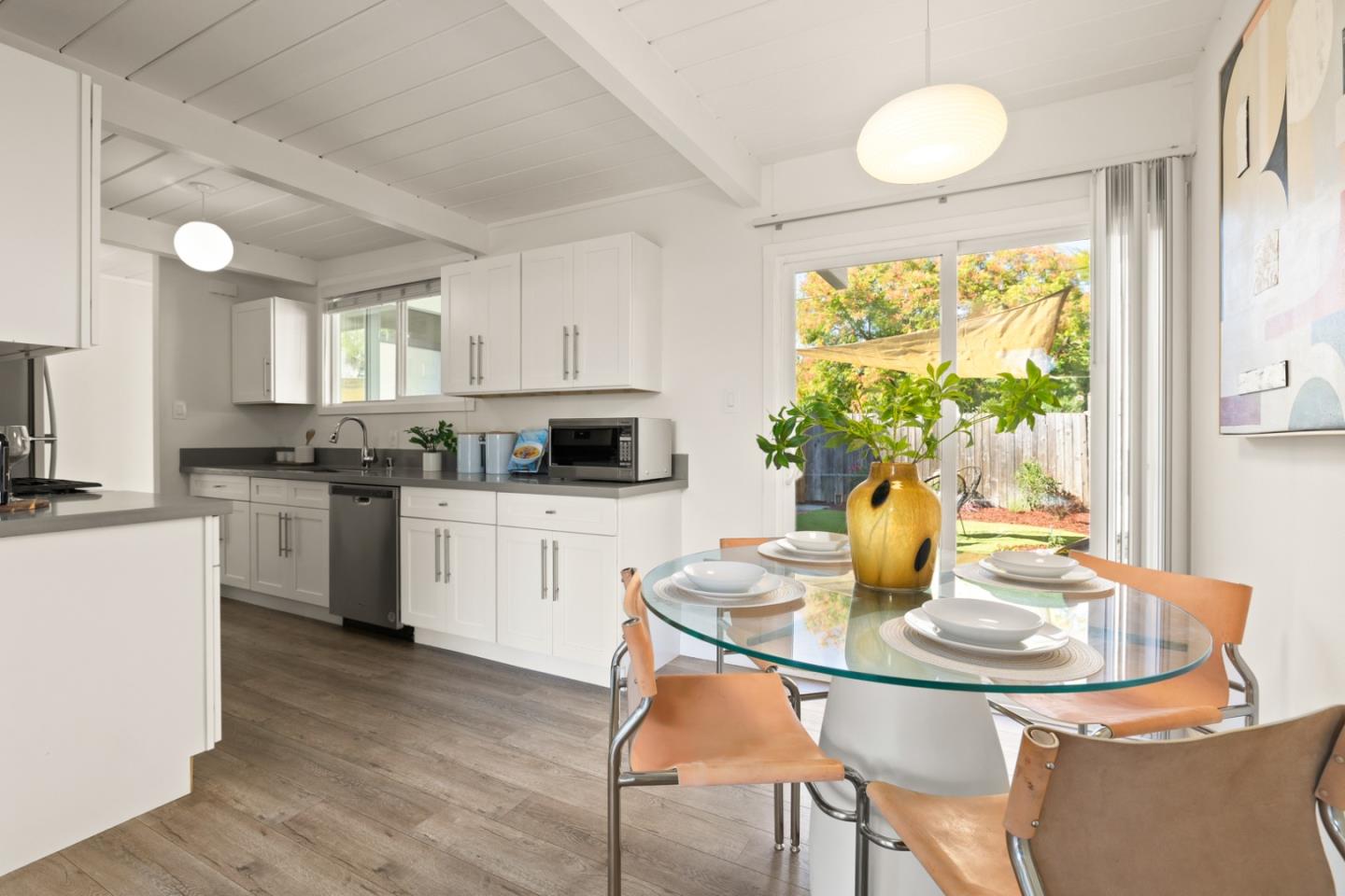 2443 Thaddeus Drive Mountain View, CA 94043 - Photo 8 of 38 a kitchen with a stove a sink a kitchen island with a dining table and chairs