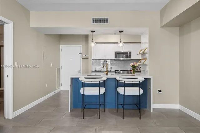 a kitchen with stainless steel appliances a sink and a refrigerator