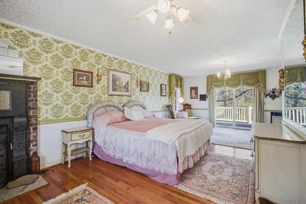 a bedroom with a bed and a chandelier