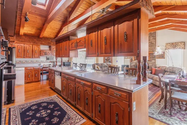 a kitchen with a sink a counter and chairs