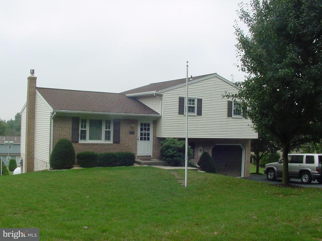 726 West Brubaker Valley Road Lititz, PA 17543 - Photo 1 of 3 a front view of a house with a garden and plants