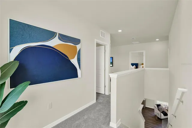 a hallway with a washer and dryer