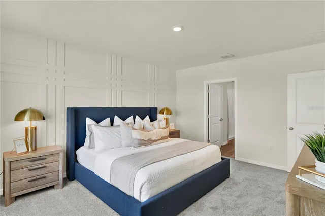 a bedroom with a bed and a potted plant