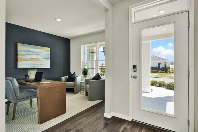 a view of a livingroom with furniture window and wooden floor