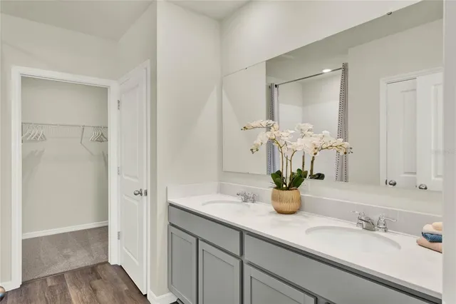 a bathroom with double vanity sinks a mirror and a shower